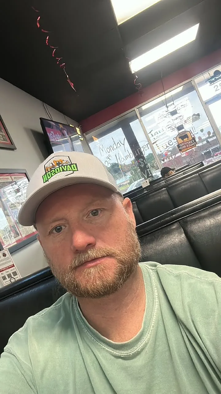 Billy Davidson, owner of Davidson Dirt Worx, wearing a company trucker hat