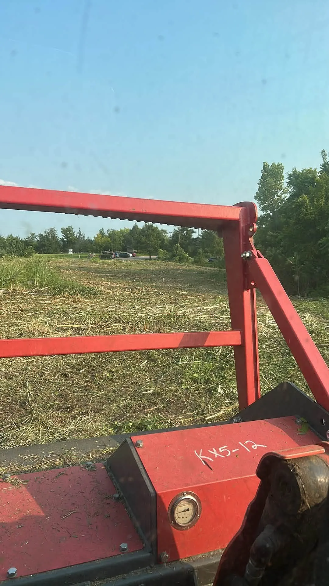 Bush hog attachment mowing tall grass on a Tennessee field
